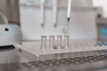 Close up of scientist is using micropipette for biochemical test analysis in medical laboratory