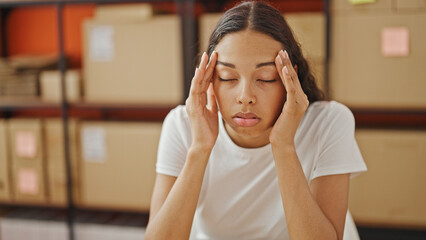 African american woman ecommerce business worker sitting on table stressed at office