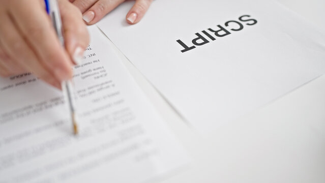 Middle age grey-haired woman reading movie script on table