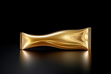 A tube of gold foil placed on a black surface. Perfect for adding a touch of luxury and elegance to any design