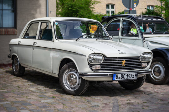 WERDER (HAVEL), GERMANY - MAY 20, 2023: The small family car Peugeot 204. Swirl bokeh. Art lens. Oldtimer - Festival Werder Classics 2023