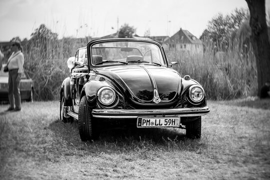 WERDER (HAVEL), GERMANY - MAY 20, 2023: The subcompact, economy car Volkswagen Beetle Convertible. Swirl bokeh, art lens. Black and white. Oldtimer - Festival Werder Classics 2023