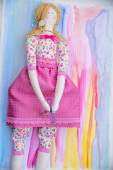 toddler doll on the colorful background, vintage style, selective focus