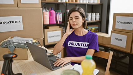 Exhausted young hispanic woman volunteer, with beautiful hairstyle and short hair, feeling...