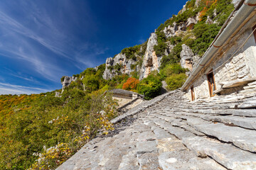 Slate roof of Agia Paraskevi monastery and the mountains of Zagori close Vikos, in the mountainous region of Epirus, in northern Greece, Europe. 