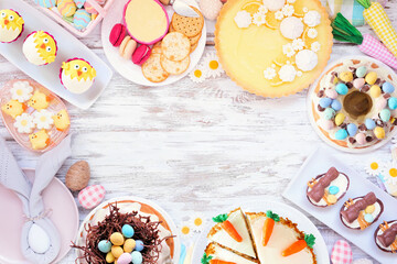 Easter or spring dessert food frame. Top down view over a white wood background. Lemon tart,...