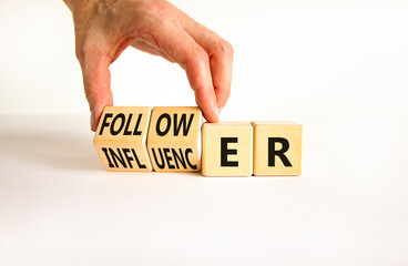 Follower or influencer symbol. Concept words Follower Influencer on wooden cubes. Beautiful white table white background. Businessman hand. Business follower influencer concept. Copy space.