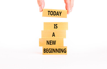 Today is a new beginning symbol. Concept words Today is a new beginning on wooden blocks. Beautiful white table white background. Businessman hand. Business today is new beginning concept. Copy space.