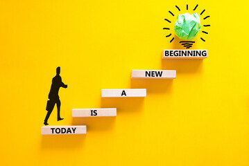 Today is a new beginning symbol. Concept words Today is a new beginning on wooden blocks. Beautiful yellow table yellow background. Businessman icon. Business today new beginning concept. Copy space