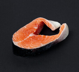 Fresh raw salmon , trout, steak on dark background. Slice of fresh raw fish.