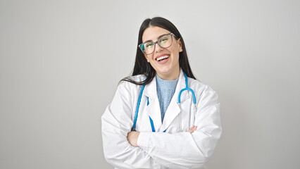 Young hispanic woman doctor smiling confident standing with arms crossed gesture over isolated white background