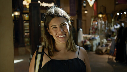 Smiling young brunette woman explores the traditional souk in dubai, embodying a blend of culture and modernity.