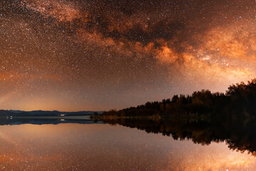 Beautiful night landscape,  bright Milky Way galaxy on the lake.