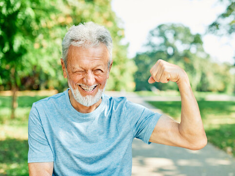 man muscle strength bicep  fitness senior strong arm muscular power training fit mature healthy body exercise confident macho motivation fun flexing