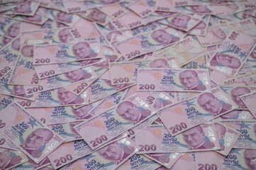 Gaziveren, Cyprus 01.27.2024-200 Turkish lira bills scattered on the table as a background 9