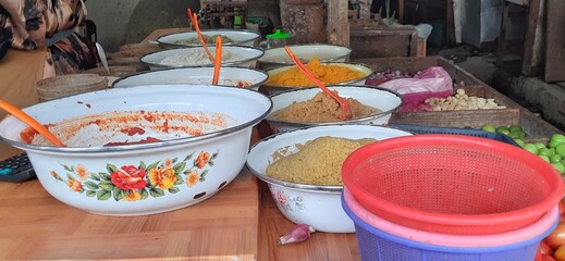 Trader of various condiments or bumbu giling or bumbu halus ingredients for cuisine, sold in Indonesian local market