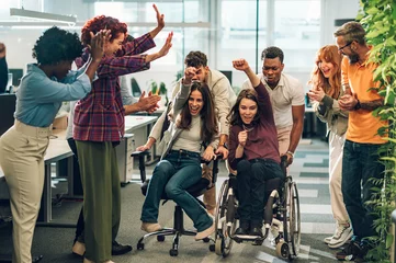 Foto op Plexiglas Portrait of a diverse inclusive people having fun and racing on office chairs © Zamrznuti tonovi