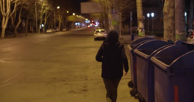 Girl running alone at night in empty streets
