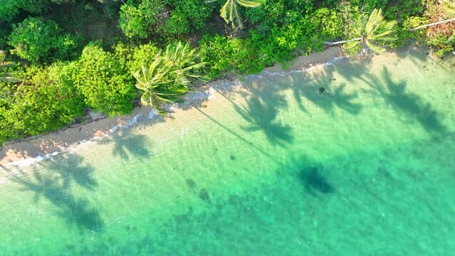 Epic tropical island captured from above. Crystal waters, sandy beaches, coconut trees sway - nature's masterpiece. World destination concept. Sea stock footage. Ko Chang, Thailand. 4K HDR.
