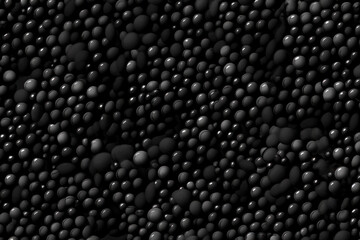 Extreme close up of a black caviar. Beautiful light and glare on fish eggs