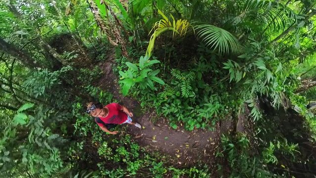 Family hiking. Man walks in the tropical forest with kid