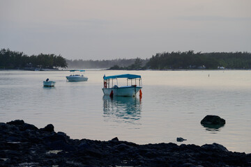 Blue Bay Beach, Mauritius - October 18 2023: Pleasure Boats Moored in a Lagoon in the Evening.