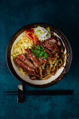 beef with vegetables on a plate with chopsticks