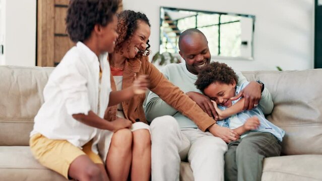 Happy, tickling and parents with kids on sofa having fun, bonding and relaxing together at home. Laughing, love and young boy children playing with mother and father in living room at house.