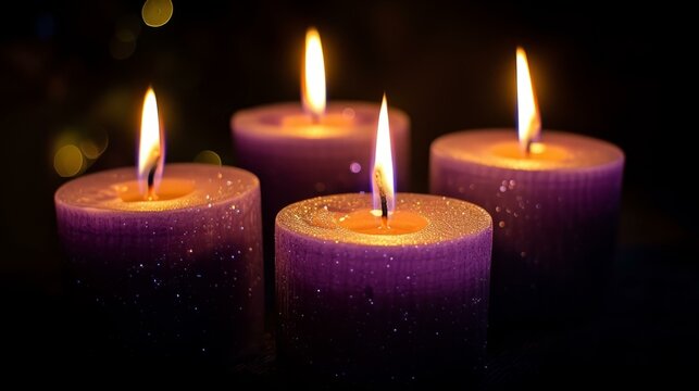Four purple candles burning in the dark