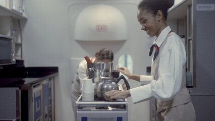 Air hostess prepares drinks for service on the plane.
