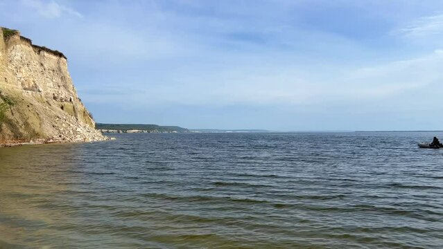 Beautiful summer view of Stepan Razin Rock on the Volga River, Saratov region, Russia. An amazing landscape with blue sky, steep cliffs and picturesque mountains with a white road. 4K