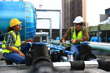 Diversity engineers wearing reflect green  safety vests and helmet  working to checking Industry...
