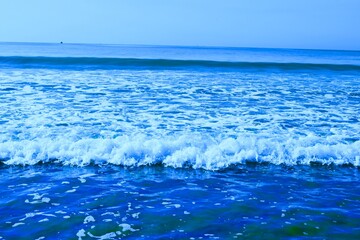 closeup sand beach with blue ocean waves. sea waves hitting the beach  
