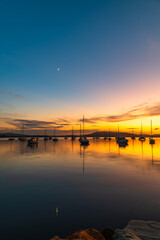 Fototapeta premium Sunrise, boats and reflections on the water