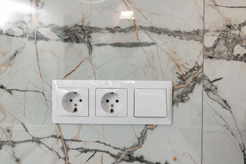 White electrical outlets on a white wall