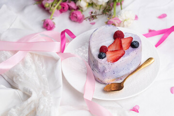 Trendy bento cake in love heart shape form on a light breakfast in bed background. Cake for Valentine's Day, Mother's Day, or Birthday, Love Forever Message, Romantic Bento Cake for Two