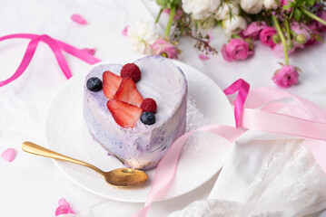 Trendy bento cake in love heart shape form on a light breakfast in bed background. Cake for Valentine's Day, Mother's Day, or Birthday, Love Forever Message, Romantic Bento Cake for Two