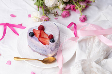 Trendy bento cake in love heart shape form on a light breakfast in bed background. Cake for Valentine's Day, Mother's Day, or Birthday, Love Forever Message, Romantic Bento Cake for Two