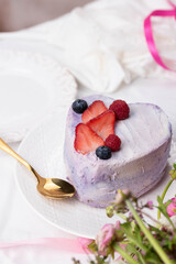 Trendy bento cake in love heart shape form on a light breakfast in bed background. Cake for Valentine's Day, Mother's Day, or Birthday, Love Forever Message, Romantic Bento Cake for Two