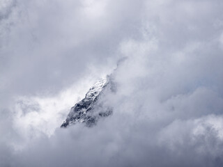 The mountain wall of Matterhorn hidden in heavy clouds and fog. Zermatt, Switzerland