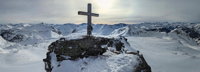 Summit cross on the Schwarzstöckli in Glarnerland. Beautiful mountain panorama. Ski mountaineering...