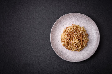 Delicious Asian cuisine dish with rice noodles, peppers, mushrooms and spices