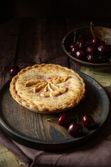 Cherry pie on dark brown background 