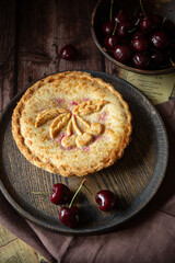 Cherry pie on dark brown background 
