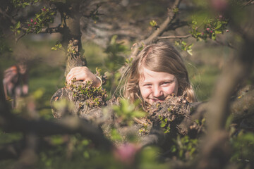 portrait of child in spring nature, relaxing and having good time - 721585971