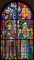  BERN, SWITZERLAND - JUNY 27, 2022: The St. Fridolin and St. Ulrich on the stained glass in the church Dreifaltigkeitskirche by A. Schweri (1938). © Renáta Sedmáková