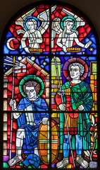  BERN, SWITZERLAND - JUNY 27, 2022: The St. Ursus of Solothurn and St. Victor on the stained glass in the church Dreifaltigkeitskirche by A. Schweri (1938). © Renáta Sedmáková