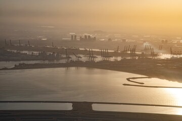 Aerial view of a huge power plant on the shore of the sea in Dubai, UAE