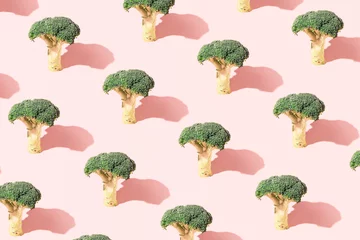 Fotobehang Broccoli, creative vegetable pattern on a pastel pink background. © Biancaneve MoSt