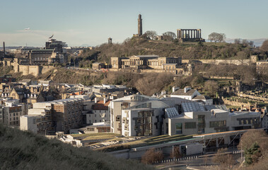 Aerial view of Calton Hill, Scottish Parliament Building with the skyline seen from the top of Salisbury Crags. Amazing Edinburgh cityscape, Destinations in Europe, Copy space, Selective focus.